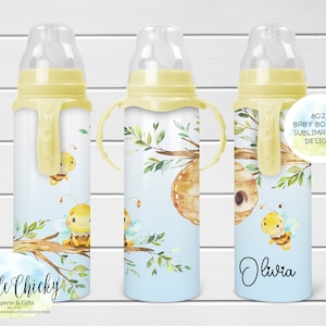 May include: 8 oz baby bottle sublimation design featuring a watercolor illustration of bees, a honeycomb, and leafy branches on a light blue background. The bottle has a yellow handle and a clear nipple. The text "Olivia" is written on the bottle.