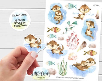 May include: A sticker sheet with 10 watercolor illustrations of otters. The otters are brown and have white bellies. Some of the otters are holding their babies. The stickers are on a white background with blue and green watercolor accents. The sticker sheet is 4.1 inches by 5.8 inches or 148 millimeters by 105 millimeters.