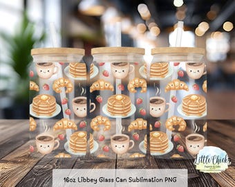 May include: Clear glass can with a wooden lid and straw, featuring a repeating pattern of pancakes, coffee cups, croissants, and strawberries. The text "16oz Libbey Glass Can Sublimation PNG" is at the bottom.