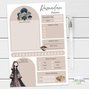 May include: A beige Ramadan planner with a mosque illustration and the text "Ramadan Planner." It includes sections for daily goals, prayer times, and Quran reading. A pen rests beside the planner.