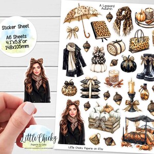 May include: A sticker sheet with a "Leopard Autumn" theme, showcasing illustrations of autumn-related items. Includes a woman with a bow, pumpkins, an umbrella, and a scarf. The sticker sheet is A6 size, measuring 10.4 cm x 14.7 cm.