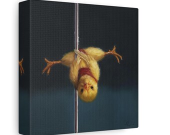May include: A canvas print featuring a yellow chick hanging upside down on a silver pole. The chick is wearing a red scarf. The background is a dark blue textured surface.