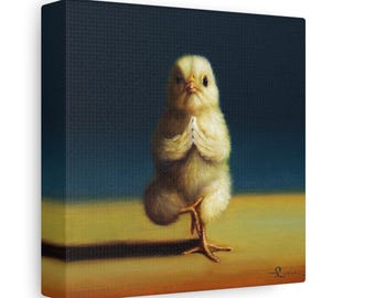 May include: A yellow baby chick stands on one leg in a yoga pose with its wings folded in front of its chest. The chick is against a blue background and a yellow surface.
