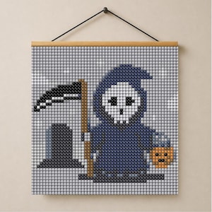 May include: A square wall hanging featuring a pixel art design of a grim reaper in a dark blue hooded robe holding a scythe and a small orange pumpkin. The artwork is composed of small circular beads and is suspended from a wooden frame.