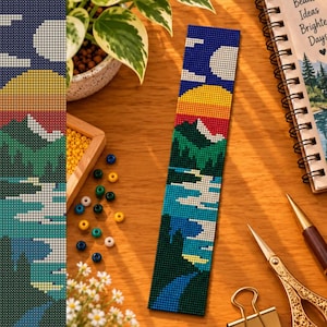 May include: A rectangular beaded bookmark featuring a landscape design with a white moon, a yellow and orange sunset, green mountains, and a blue lake. The pattern is created with small, uniform beads arranged in a grid, depicting a serene nature scene.