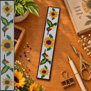 May include: A rectangular beaded bookmark featuring a repeating pattern of yellow sunflowers with brown centers and green leaves, alternating with small hummingbirds in shades of green, yellow, and red, all set against a white background.