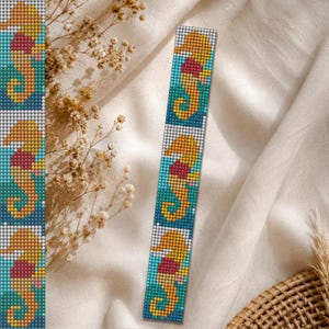 May include: A beaded bookmark featuring a seahorse design. The seahorses are yellow and red, set against a turquoise background. The bookmark is rectangular and made of small, colorful beads. The design is repeated multiple times along the length of the bookmark.