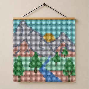 May include: A square wall hanging featuring a pixelated landscape design composed of small circular beads. The scene depicts a blue sky, a yellow sun, grey mountains, pink hills, green pine trees, and a winding blue river flowing through.
