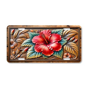 May include: A decorative license plate featuring a detailed relief of a red hibiscus flower with green and yellow leaves. The flower is set against a wood-grain background, with a brown border.