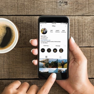 May include: A smartphone displaying an Instagram profile with the username "hillyyy". The profile has 347 posts, 6,821 followers, and 954 following. The profile picture is of a person with brown hair and a beard. The profile bio reads "Cole Hilton, Seattle, WA. Photographer. www.colehilton.com. Followed by shane.travels, flickmatched and 28 others."