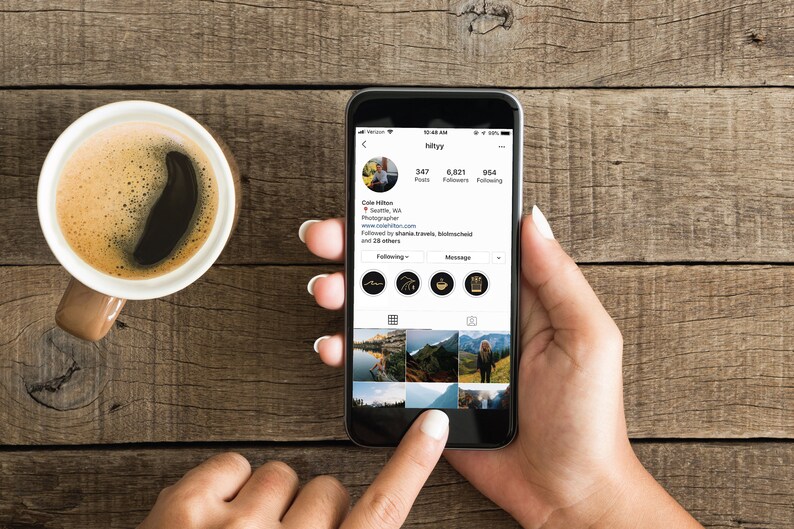 May include: A smartphone displaying an Instagram profile with the username "hillyyy". The profile has 347 posts, 6,821 followers, and 954 following. The profile picture is of a person with brown hair and a beard. The profile bio reads "Cole Hilton, Seattle, WA. Photographer. www.colehilton.com. Followed by shane.travels, flickmatched and 28 others."