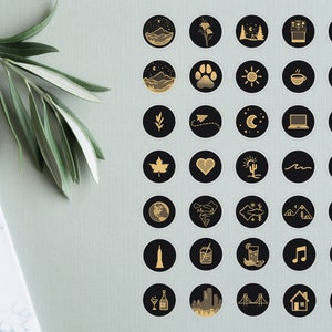 May include: A set of 36 black and gold Instagram highlight covers with various icons, including mountains, a paw print, a sun, a coffee cup, a fork and knife, a leaf, a paper airplane, a crescent moon, a laptop, a road, a maple leaf, a heart, a cactus, a wave, an airplane, a globe, a mountain range, a star, a van, a skyscraper, a mason jar, a glass of lemonade, a music note, a dumbbell, a champagne flute, a cityscape, a bridge, a house, and a building.