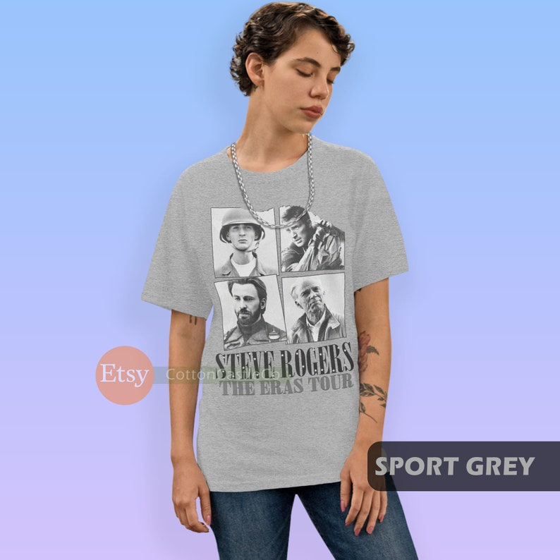May include: A grey t-shirt with a black and white image of Steve Rogers from the Marvel Cinematic Universe. The image shows Steve Rogers in four different stages of his life, from his childhood to his time as Captain America. The text "Steve Rogers The Eras Tour" is printed below the image.