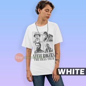 May include: White t-shirt with a black and white image of four different versions of Steve Rogers from the Marvel Cinematic Universe. The text "Steve Rogers The Eras Tour" is printed below the images.