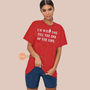 May include: A red t-shirt with the text "I'M WITH YOU TILL THE END OF THE LINE" in white. The shirt is paired with navy blue shorts. The image is of a person wearing the outfit.