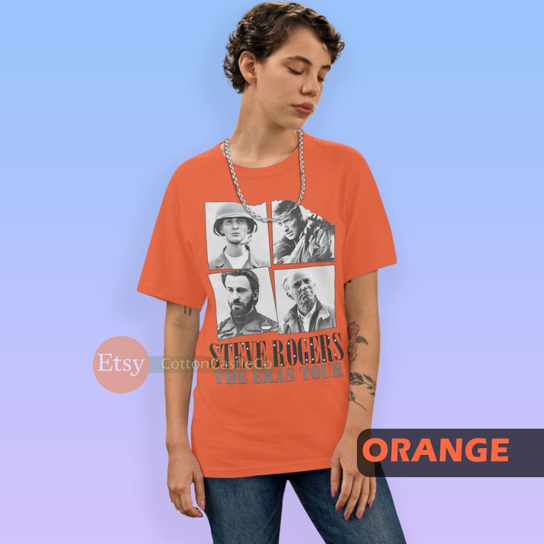 May include: Orange t-shirt with a graphic of Steve Rogers from the Marvel Cinematic Universe. The graphic features four images of Steve Rogers from different points in his life, including his time as a soldier in World War II and as Captain America. The text "Steve Rogers The Eras Tour" is printed below the images.
