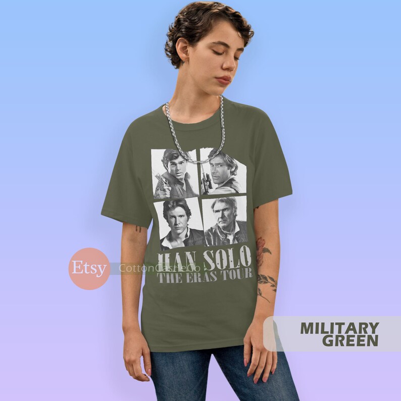 May include: A green t-shirt with a black and white image of Han Solo from Star Wars. The shirt has the text "Han Solo The Eras Tour" printed on it.