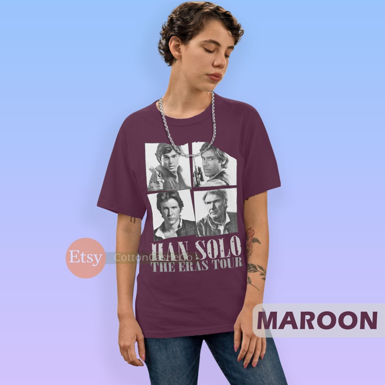 May include: Maroon t-shirt with a graphic of four images of Han Solo from different Star Wars movies. The text "Han Solo The Eras Tour" is printed on the shirt.