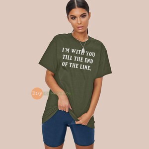 May include: Olive green t-shirt with the text "I'M WITH YOU TILL THE END OF THE LINE" in white. The shirt is paired with navy blue shorts. The Etsy shop logo "CottonCastleCo" is visible in the bottom left corner.