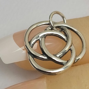 May include: Silver Celtic knot pendant charm with a loop for attaching to a necklace or bracelet.