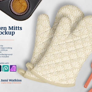 May include: A pair of beige oven mitts with a white geometric pattern. The mitts are made of quilted fabric and have a scalloped edge. The mitts are lying on a white surface with two orange spoons.
