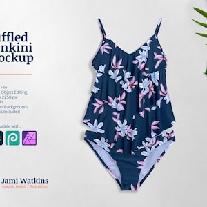 May include: A blue tankini swimsuit with a ruffled top and a floral print. The print features pink and white flowers on a dark blue background.