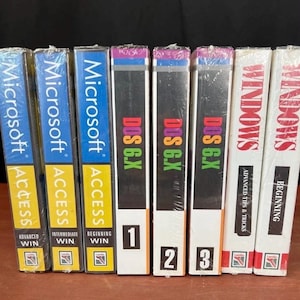 May include: A collection of eight software instructional books wrapped in plastic. The spines feature titles including Microsoft Access, DOS 6.X, and Windows, with volume numbers and labels such as Beginning, Intermediate, and Advanced Win printed on them.