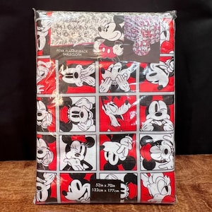 以下が含まれることがあります： パッケージされたミッキーマウスPEVAフランネルバックテーブルクロス。赤と黒のテーブルクロスは、さまざまなミッキーマウスのポーズのグリッドパターンが特徴です。パッケージには「52in x 70in」（132cm x 177cm）と記載されています。