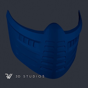 Puede incluir: Una máscara facial azul oscuro con un diseño geométrico. La máscara tiene forma curva y presenta aberturas rectangulares. El texto "RW 3D STUDIOS" está en la esquina inferior izquierda.