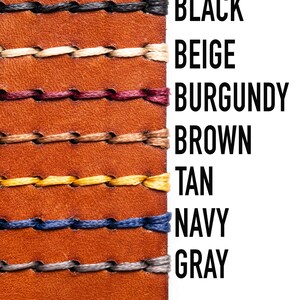May include: A close-up of a leather strap with stitching in various colors, including black, beige, burgundy, brown, tan, navy, and gray. The colors are labeled on the right side of the image.