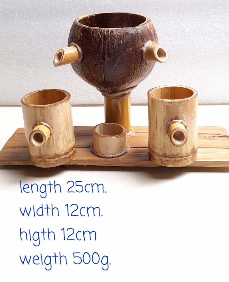 May include: A wooden serving set with a coconut shell bowl and three bamboo cups. The set is 25 inches long, 12 inches wide, and 12 inches high. It weighs 500 grams.