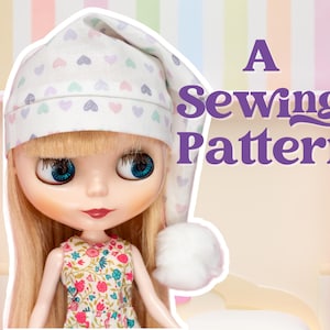 May include: A doll wearing a white nightcap with pastel heart patterns and a floral dress. The text "A Sewing Pattern" is displayed in purple. The doll has blonde hair and large blue eyes.