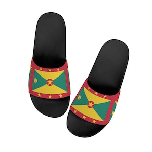 May include: Pair of black slide sandals with a red, yellow, and green Grenadian flag design.