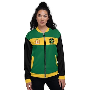 May include: A green, yellow, and black bomber jacket with the Jamaican flag colors. The jacket has a zipper closure, black sleeves, and the words "Out of Many, One People" on the chest.