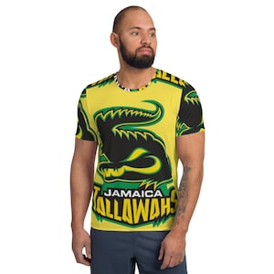 May include: A yellow short-sleeved shirt with a black alligator graphic and the text "Jamaica Tallawahs" in green and yellow.