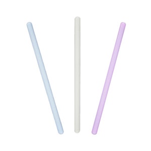 May include: Three glass stirring sticks in different colors: light blue, white, and light purple.