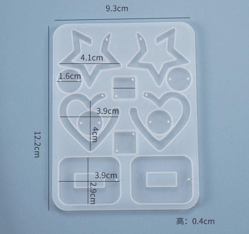 May include: A clear silicone mold for making earrings. The mold has 10 different shapes, including stars, hearts, and squares. The mold is 9.3 cm wide, 12.2 cm tall, and 0.4 cm thick.