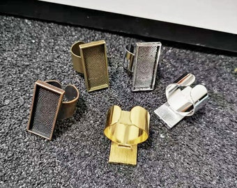 May include: Four adjustable ring blanks with a textured surface. The blanks are in gold, silver, and bronze.