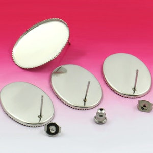 May include: Three silver oval-shaped earring blanks with a post and a backing. The blanks are smooth and have a shiny finish.