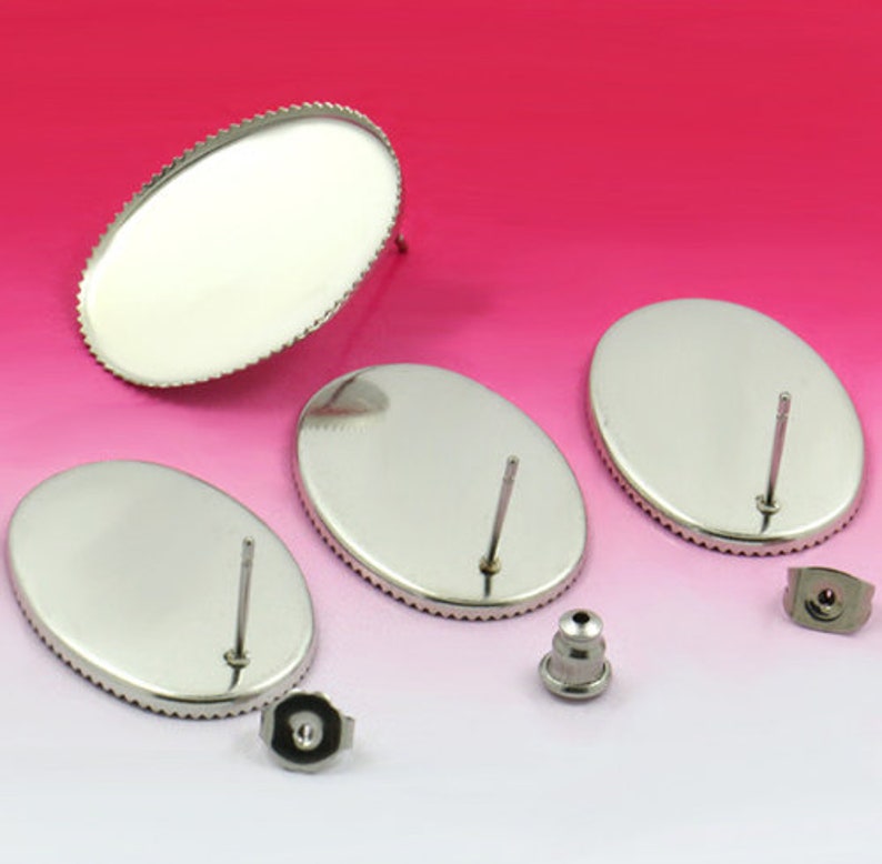 May include: Three silver oval-shaped earring blanks with a post and a backing. The blanks are smooth and have a shiny finish.