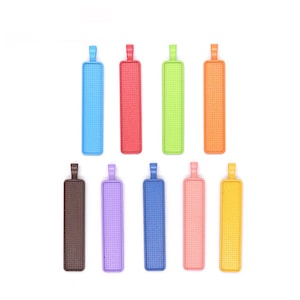 May include: Ten colourful rectangular metal pendant blanks with a textured surface. The blanks are in various colours including blue, red, green, orange, brown, purple, pink, yellow, and light blue.