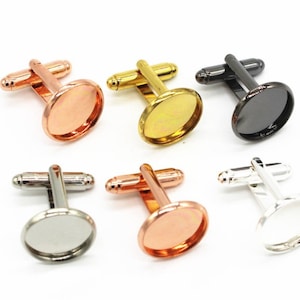 May include: Six cufflinks with round, flat, metal bases. The bases are in different colors: rose gold, gold, black, silver, and two different shades of rose gold. The cufflinks are designed to be used with a cameo or other decorative insert.