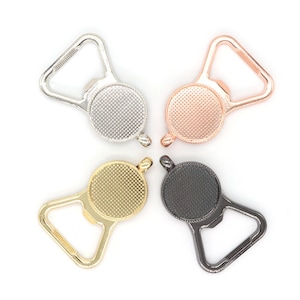 May include: Four bottle openers with different finishes: silver, rose gold, gold, and black. Each opener has a round, textured top and a triangular opening.