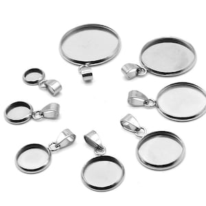 May include: A set of ten silver-toned metal pendant trays with round bezels. The trays are designed for use with resin or other materials to create custom jewelry.