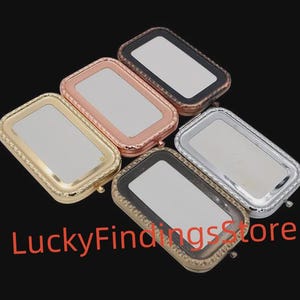 May include: An assortment of rectangular compact mirrors in gold, rose gold, silver, and black. Each mirror has a decorative border and a reflective surface. The text "LuckyFindingsStore" is in red.