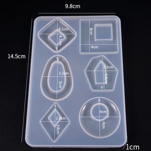 May include: Clear silicone mold with seven different shapes for resin casting. The mold measures 9.8 cm by 14.5 cm and includes shapes like a rectangle, oval, diamond, and a pentagon.
