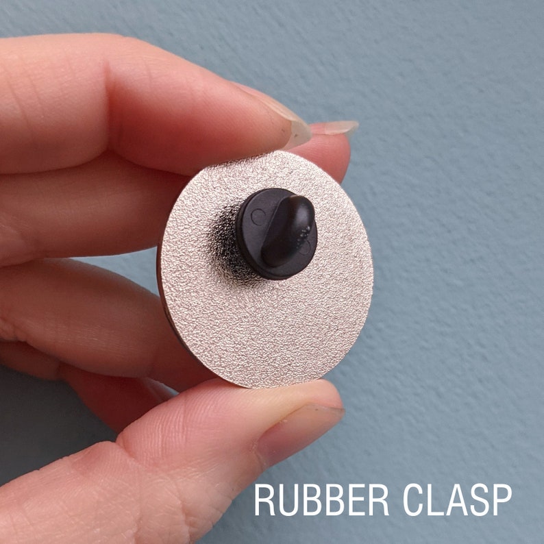 The back of an enamel pin with a rubber clasp.