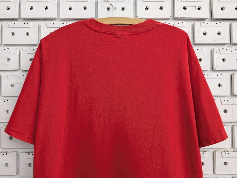 May include: A plain red t-shirt with short sleeves.
