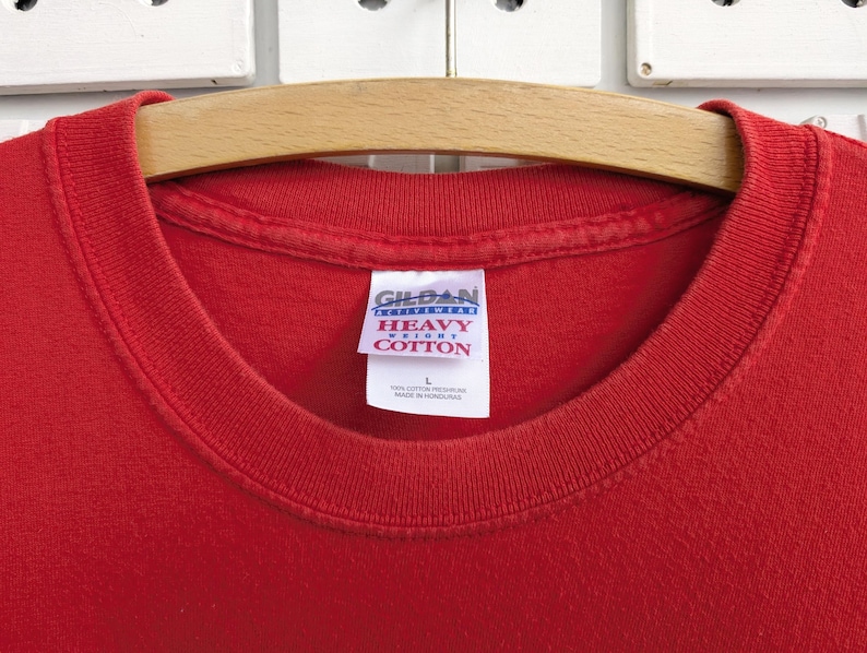 May include: Red t-shirt with a white Gildan "Heavy Cotton" tag.
