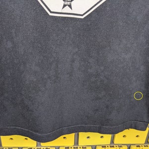 May include: Black t-shirt with a white graphic of a star and the word "Army".